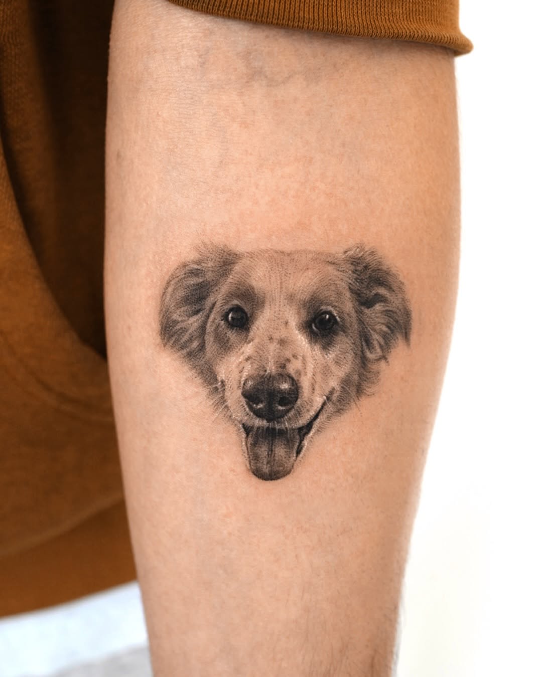 Realistic grayscale dog head with tongue-out expression.