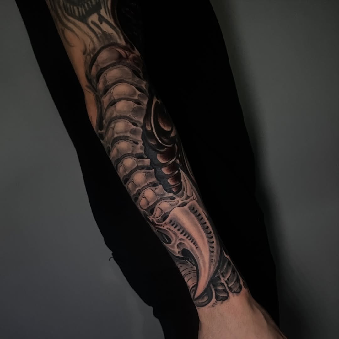 Intricate blackwork biomechanical forearm sleeve with gears