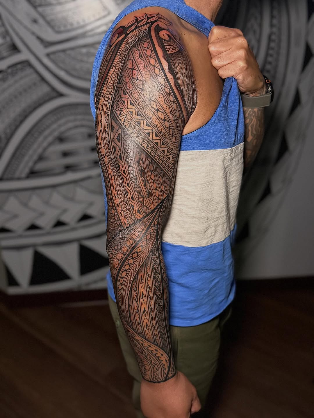 Intricate black Polynesian geometric sleeve with bold linework.