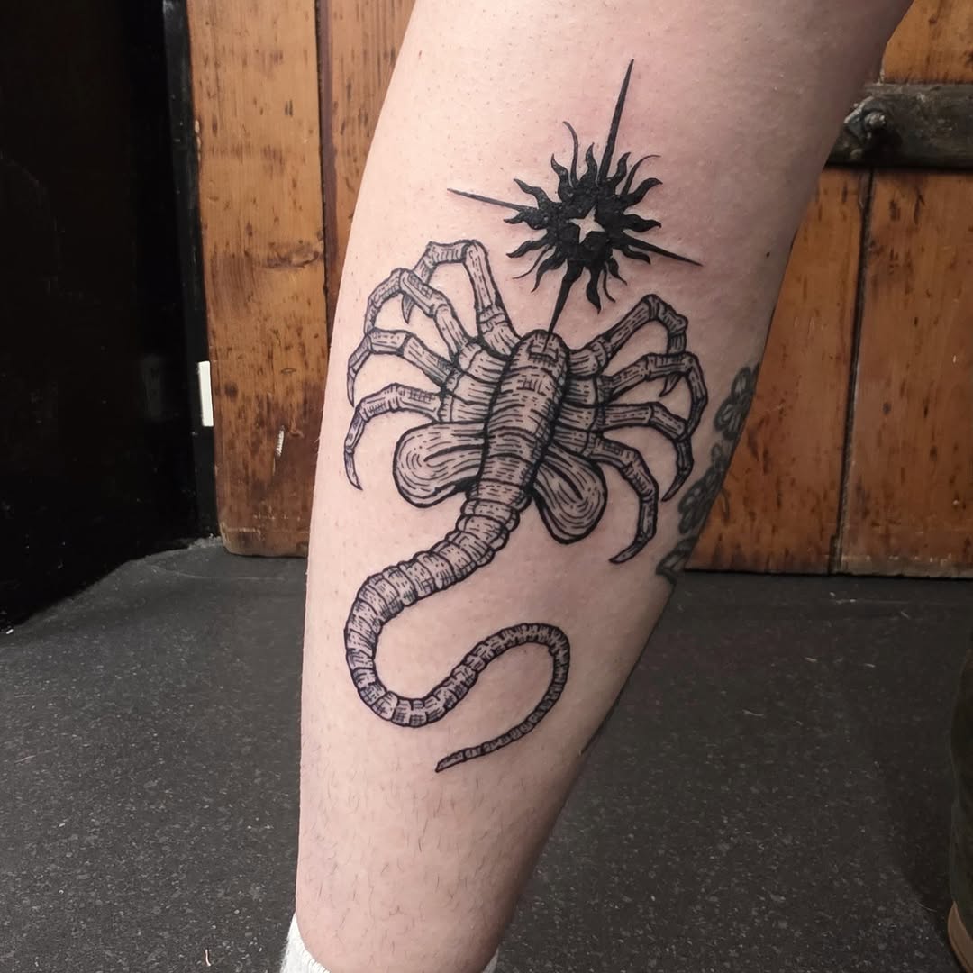 Bold woodcut-style scorpion with sunburst accent