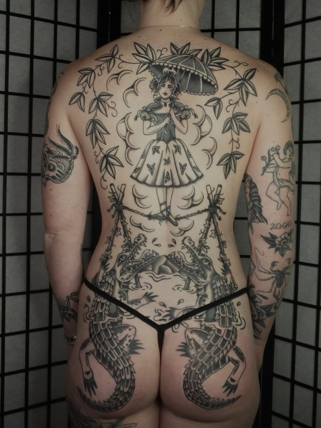 Parasol-clad woman framed by bamboo, koi-dragons.