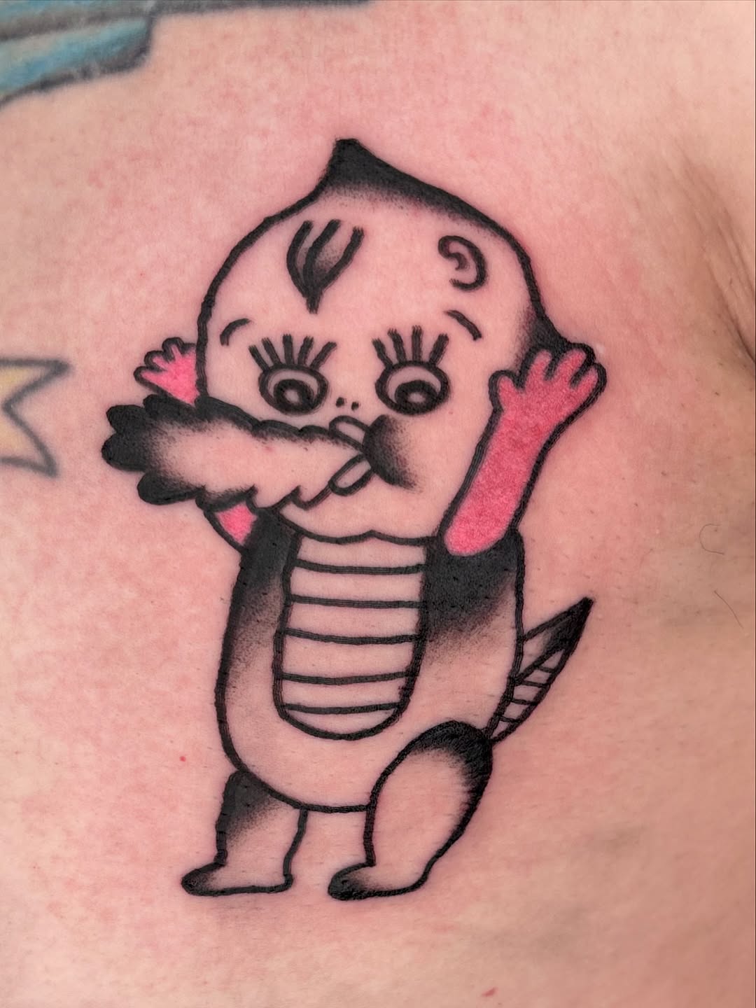 Kewpie-inspired baby dinosaur with bold outlines and pink accents