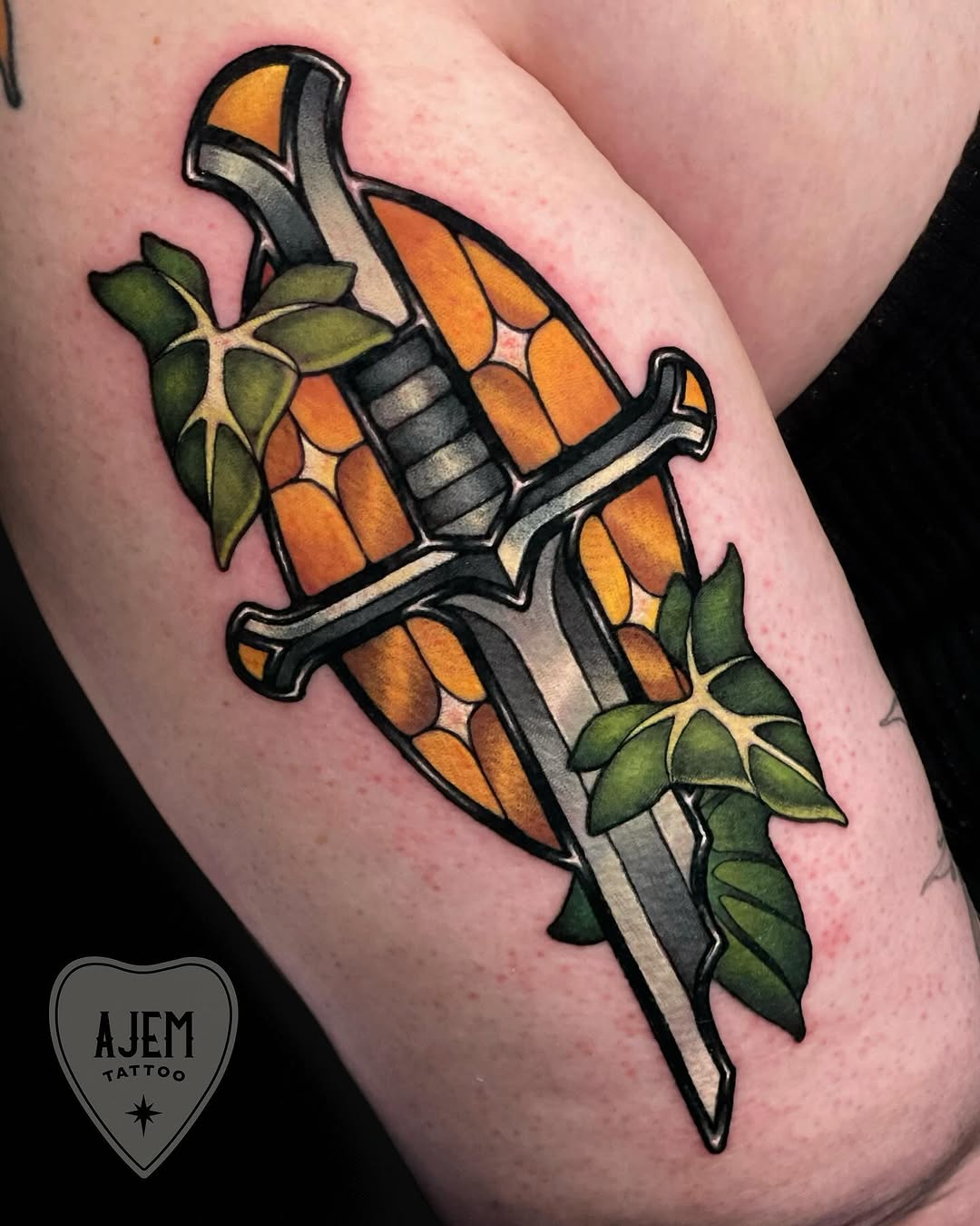 Stained-glass Narsil sword woven with ivy.