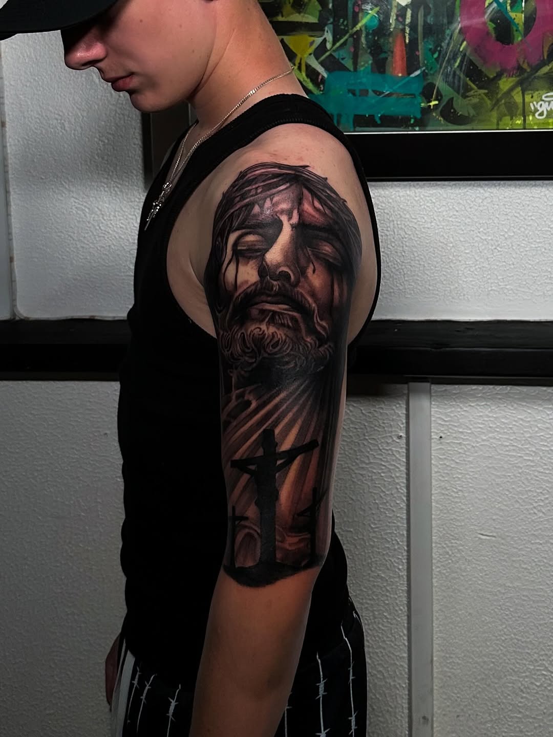 Intense black-and-gray Jesus portrait with crucifixion cross