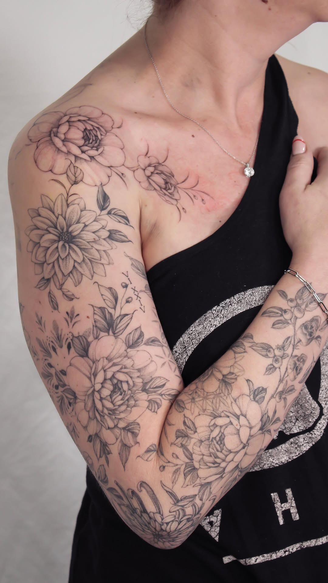 Elegant black-and-gray floral sleeve with lush peonies