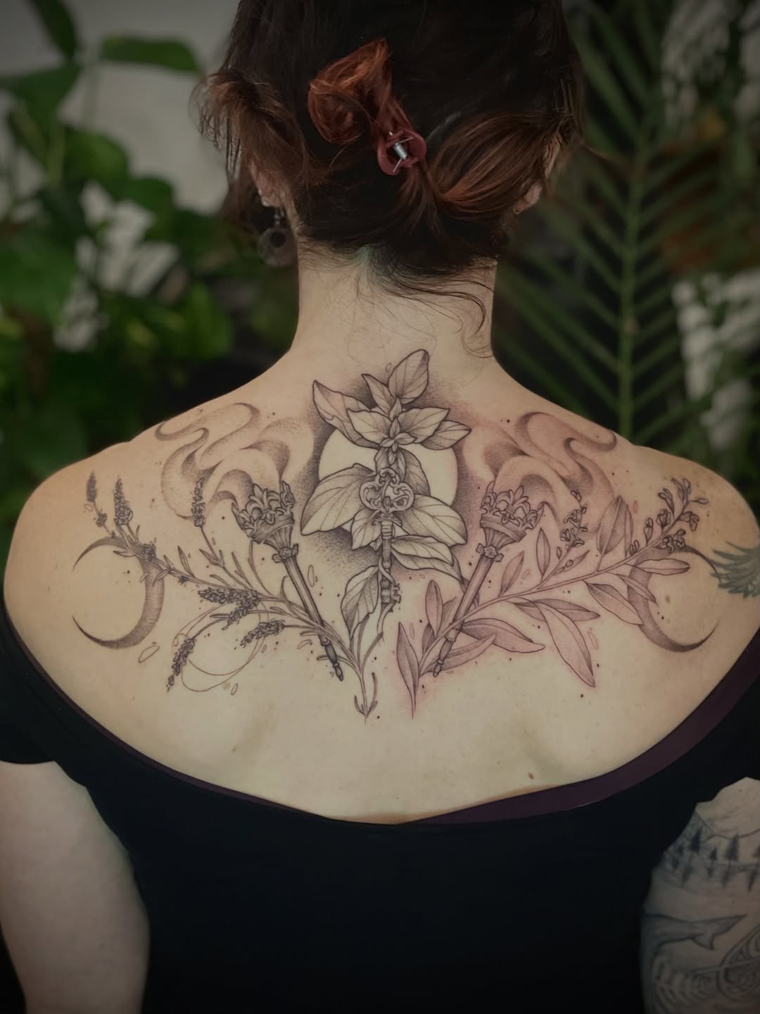 Elegant lunar botanical back piece with delicate linework