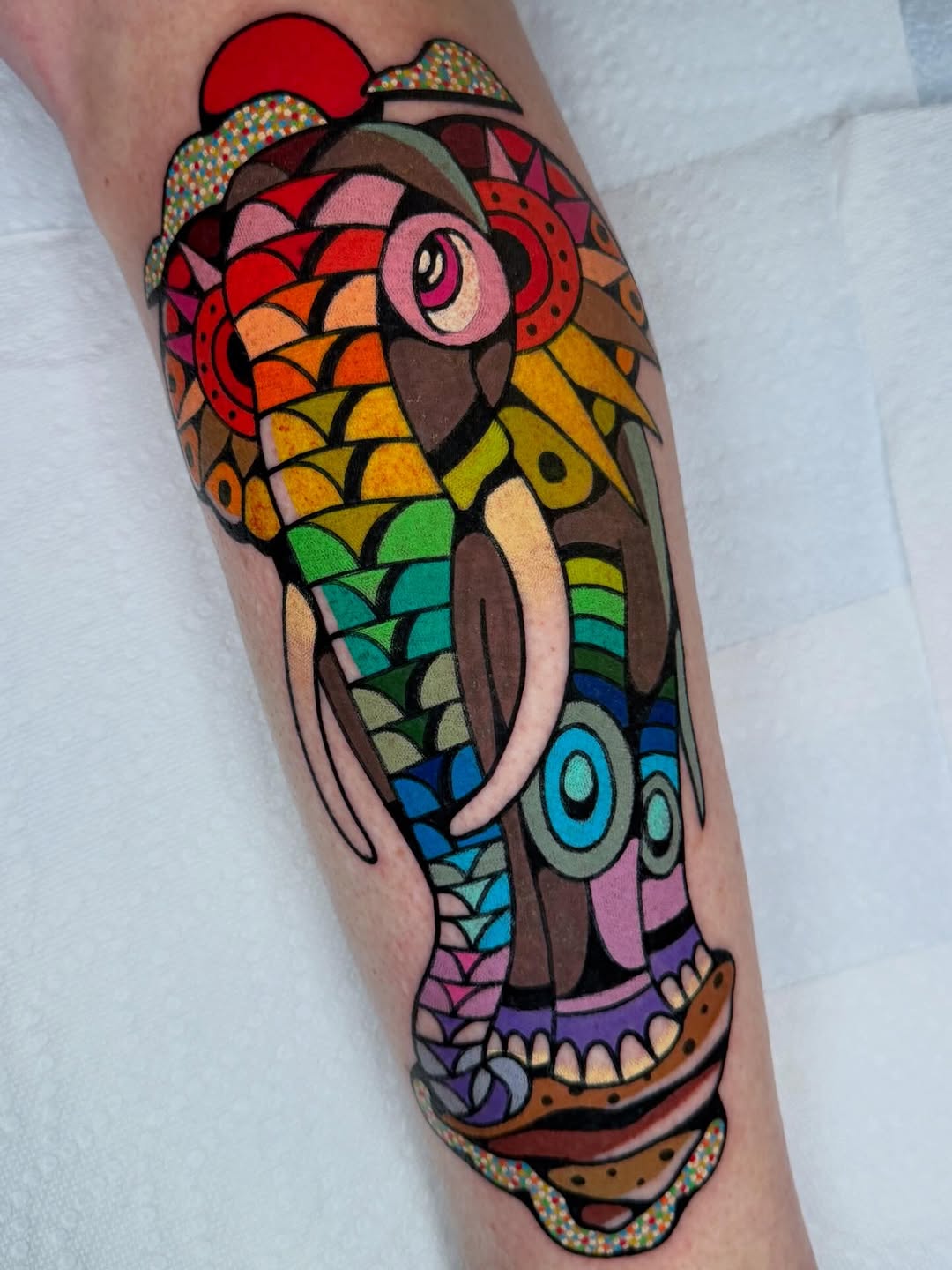 Vibrant mosaic elephant tattoo with bold black outlines.