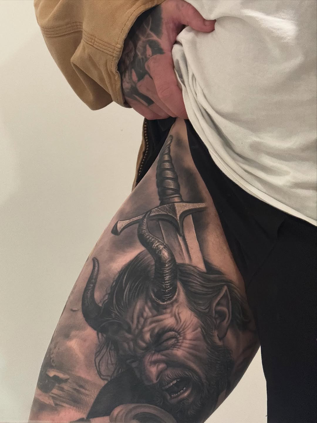 Hyper-detailed black-and-gray demon portrait with curling horns