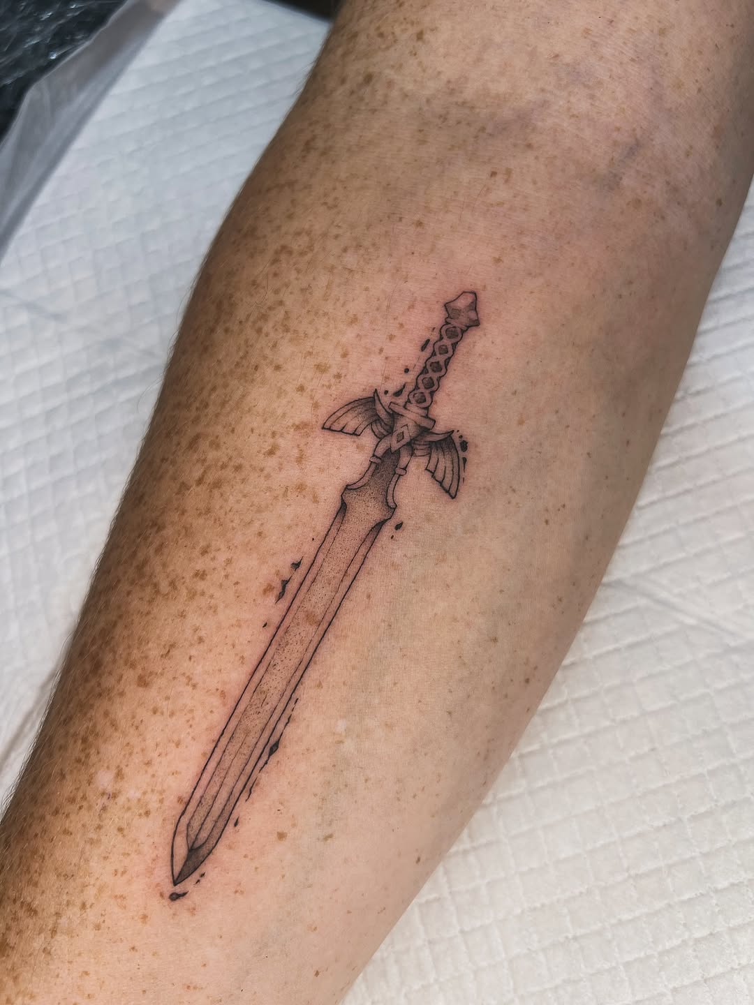 Master Sword-inspired linework with winged guard, minimalist.