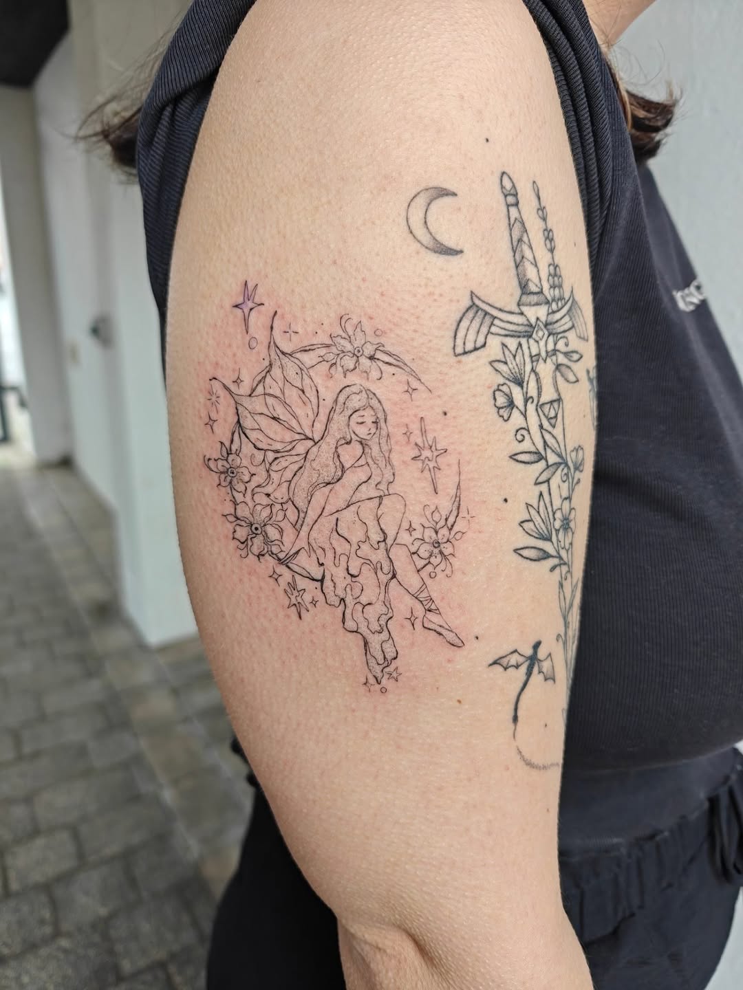 Delicate fineline fairy with moon and sword entwined by blossoms