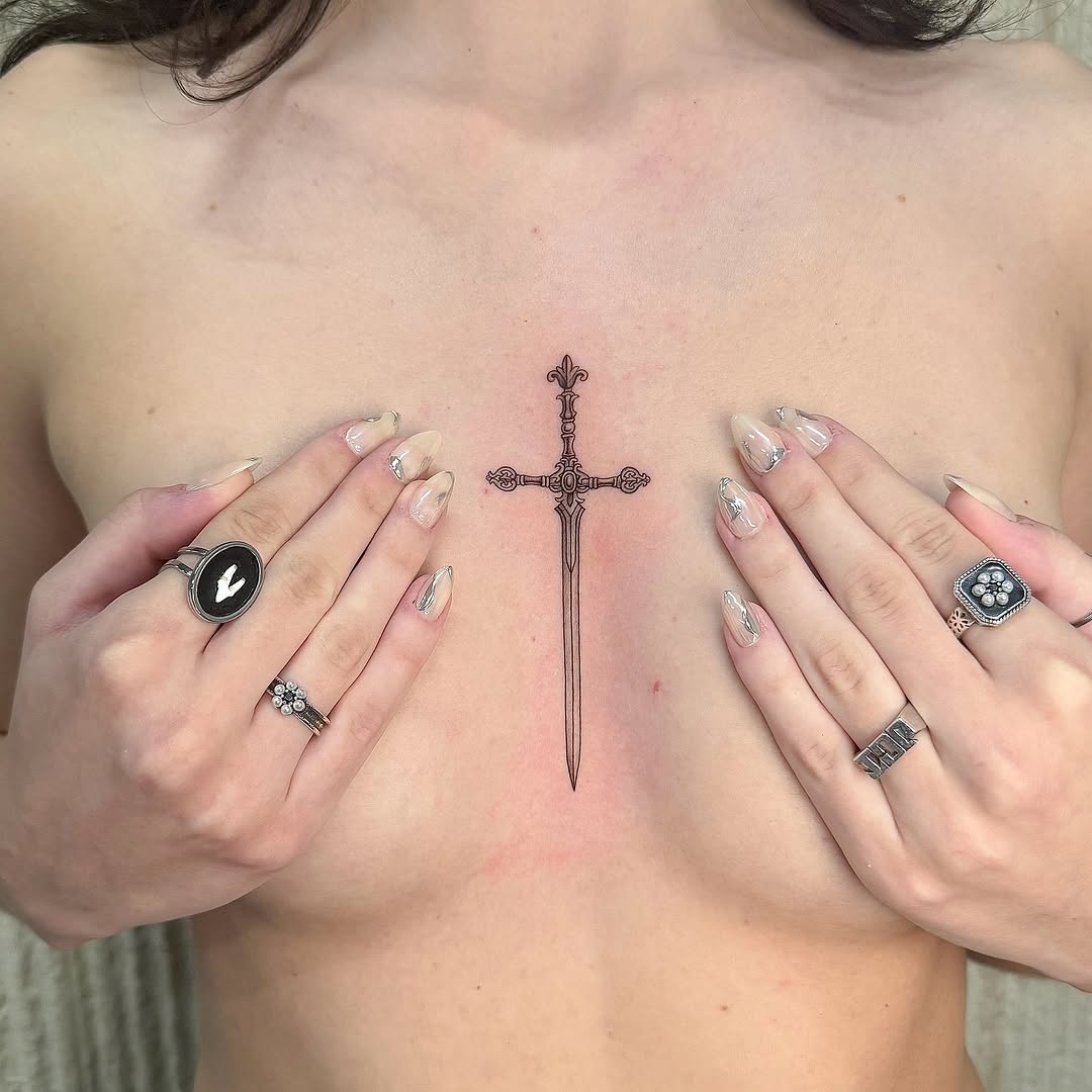 Exquisitely detailed fine-line sword-cross with ornate hilt.