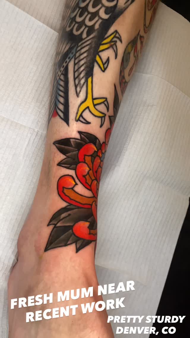 Bold traditional floral with vivid red-orange petals