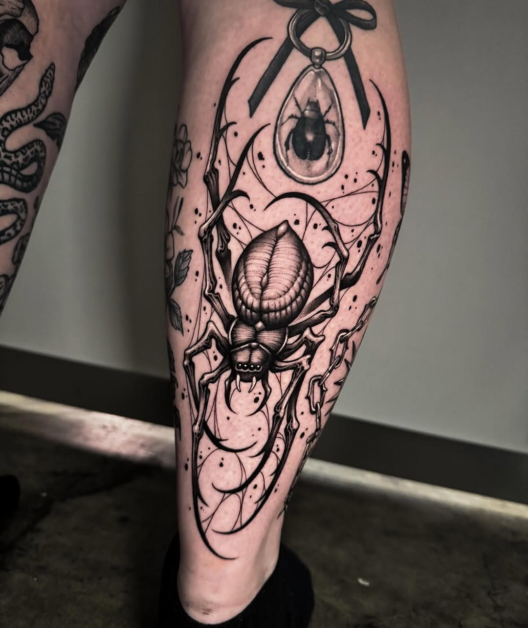 Elaborate blackwork spider with sweeping linework and dot shading