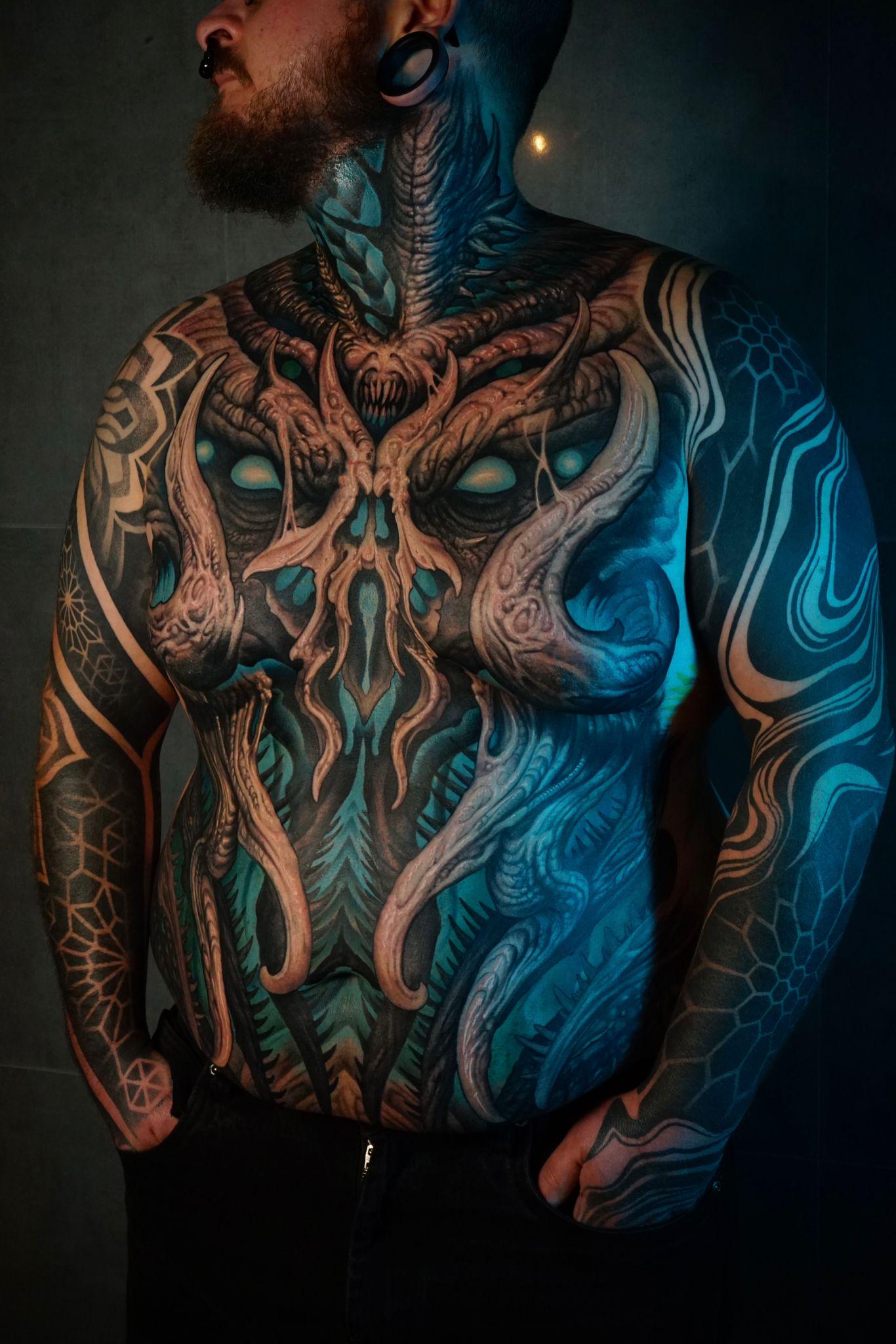 Intricate black-and-gray biomechanical tentacle torso sculpture