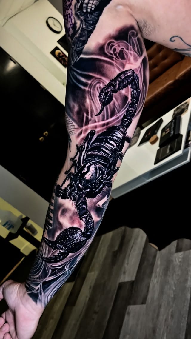 Hyper-detailed blackwork scorpion on the forearm, dramatic shading.