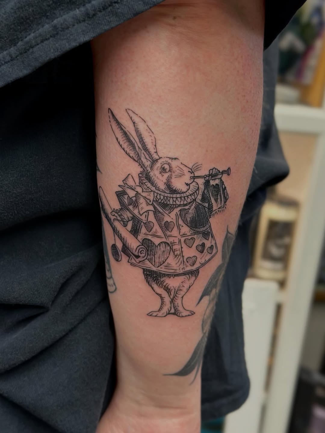 Whimsical rabbit in ornate heart-patterned vest.