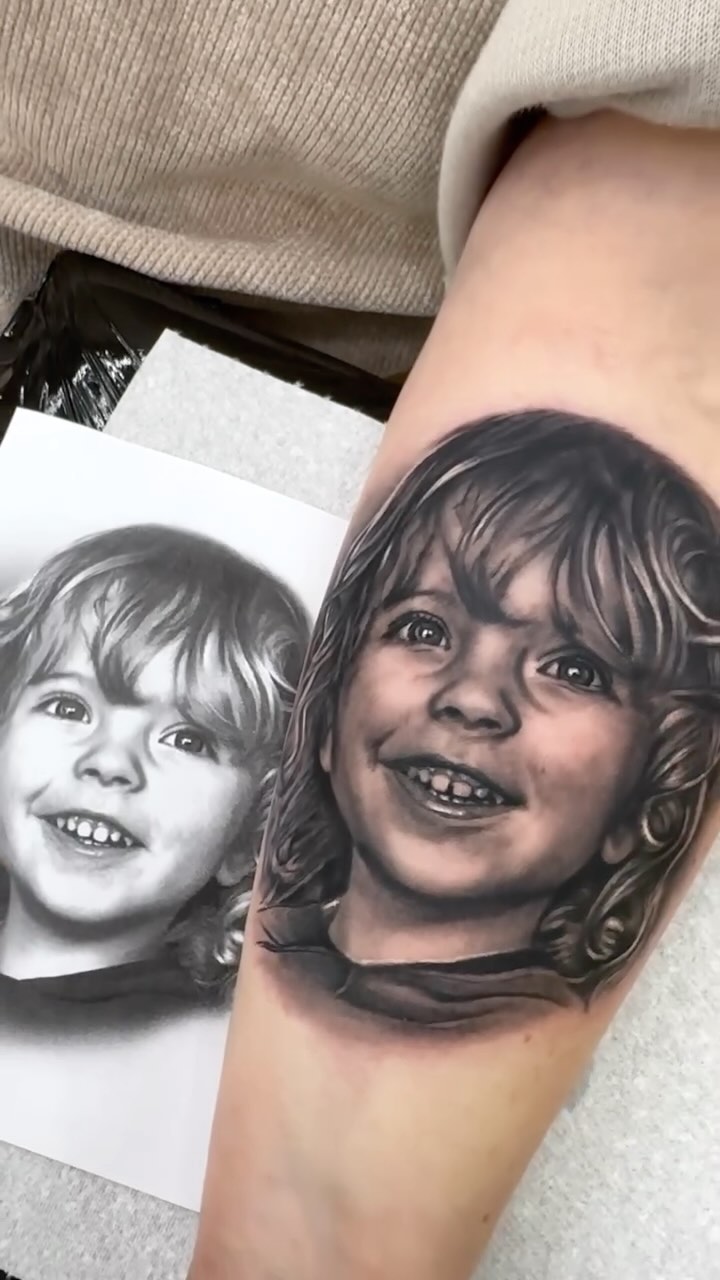 Hyper-realistic grayscale baby portrait with soft, lifelike shading.