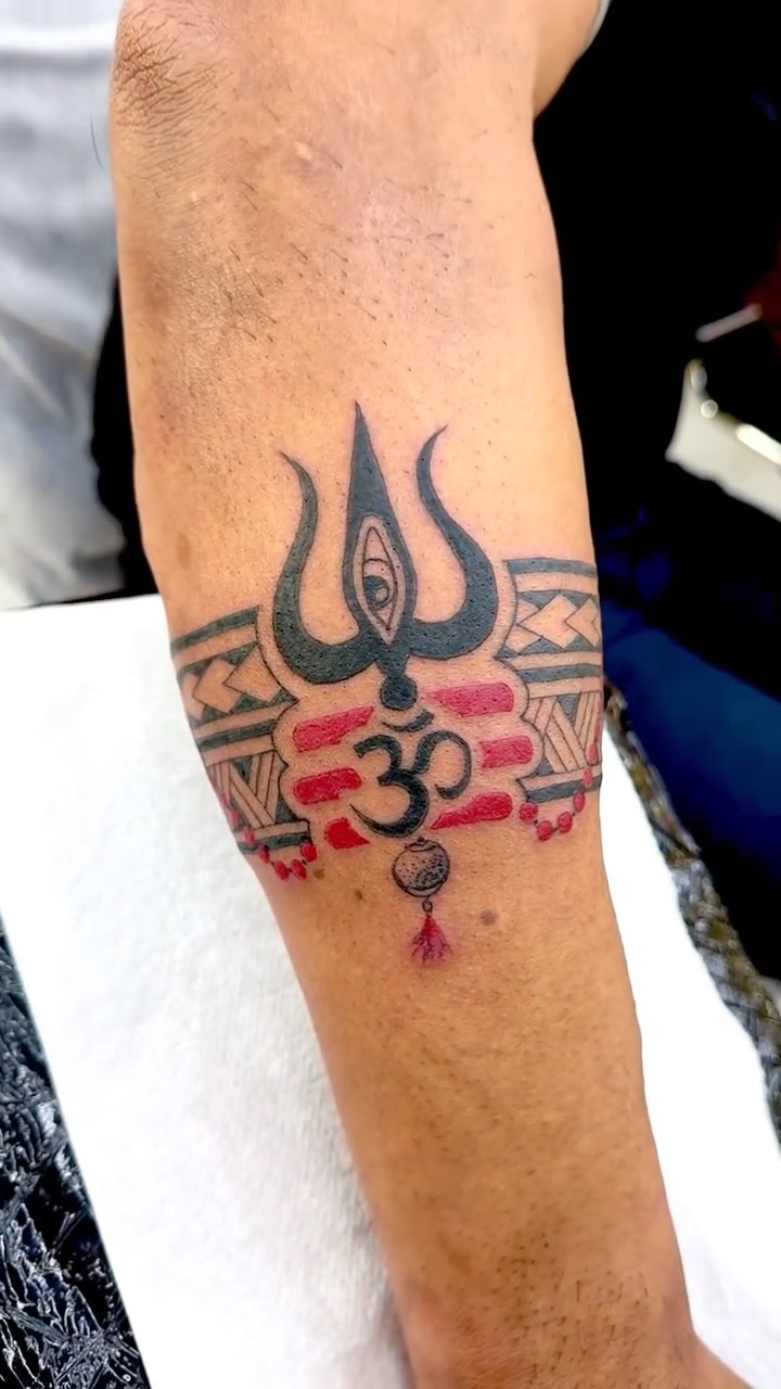 Bold armband motif featuring trishula and Om symbols