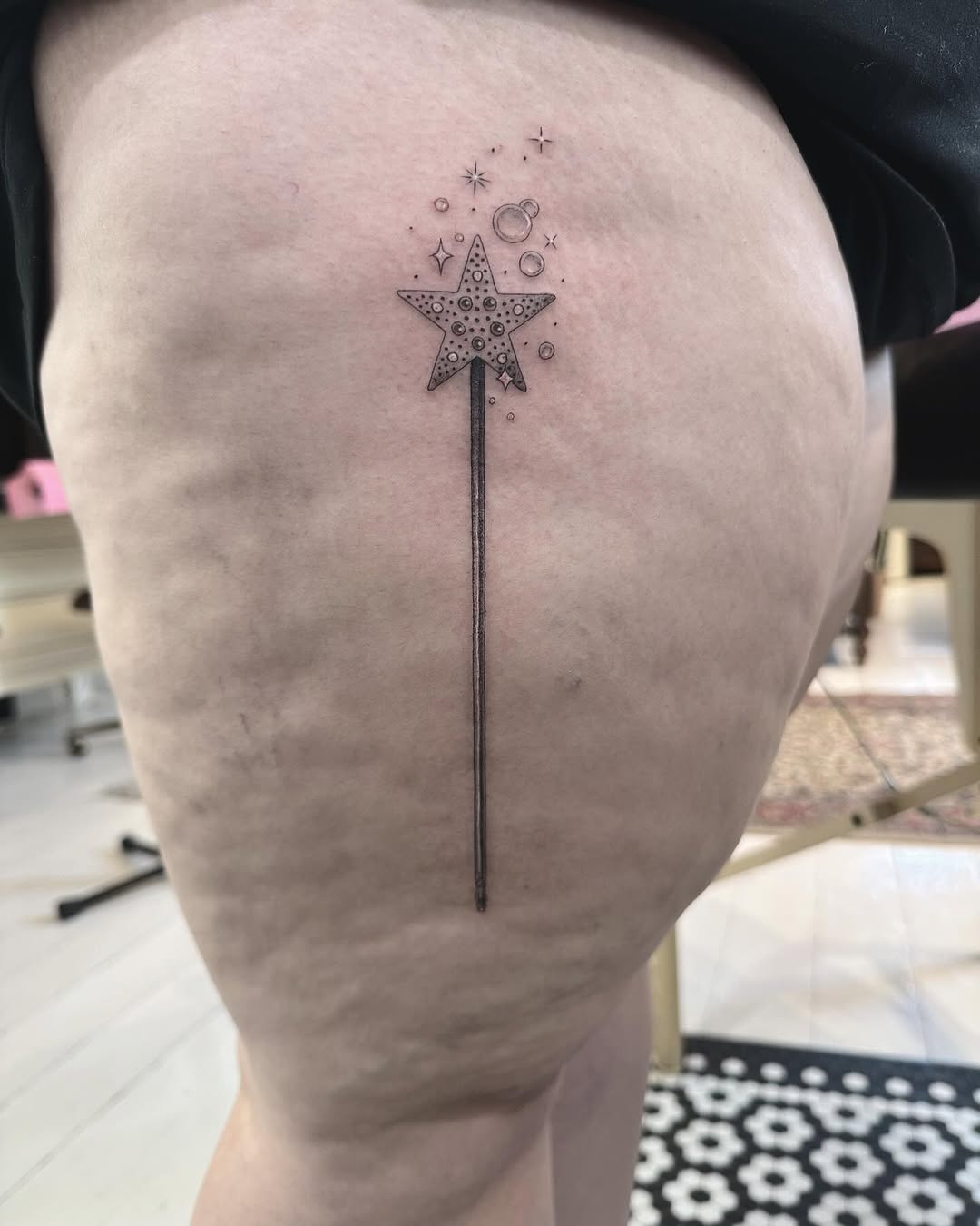 Slim fine-line wand with dotted star cap, cosmic bubbles.