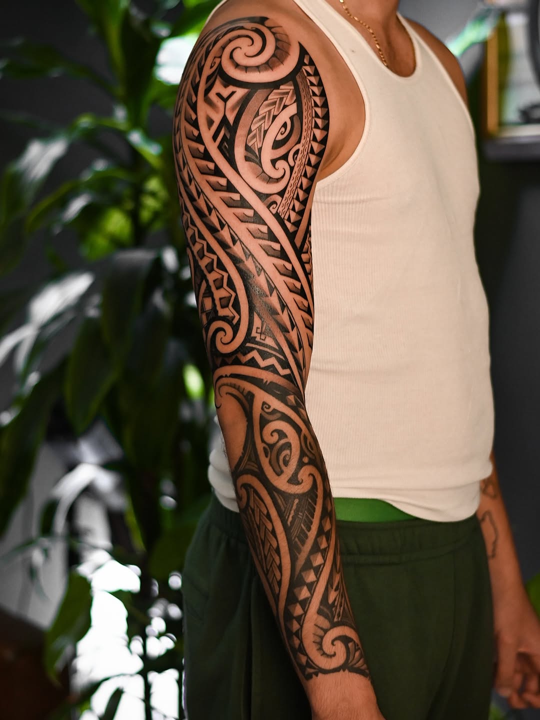 Bold Polynesian blackwork sleeve with intricate geometric panels