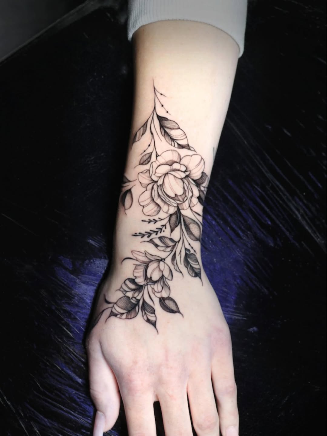 Delicate black floral vine with blooming roses