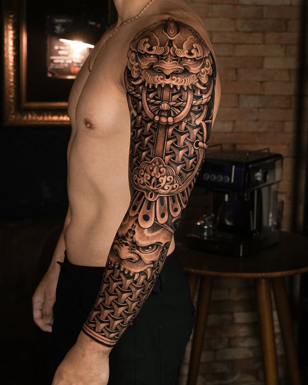 Intricate black-and-gray full-sleeve armor motif with demon mask