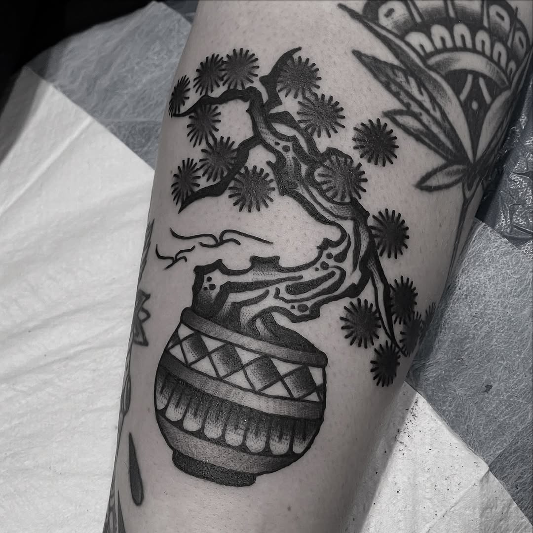 Bonsai-inspired blackwork tree with radiating blossom motifs