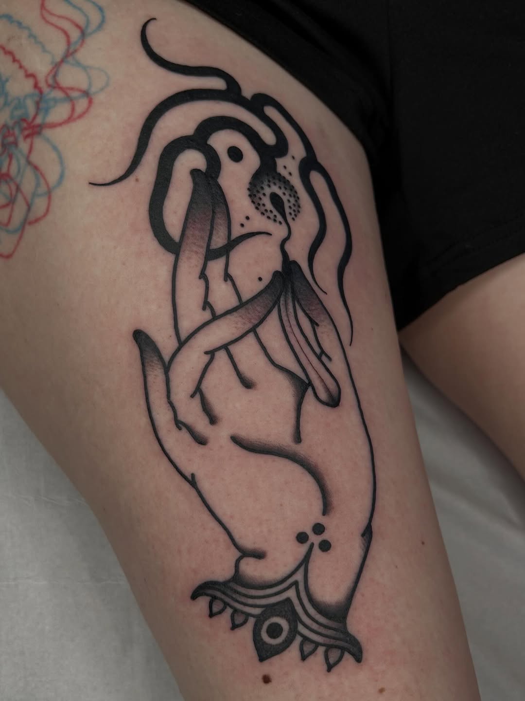 Bold black-line abstract hand motif with ornamental base