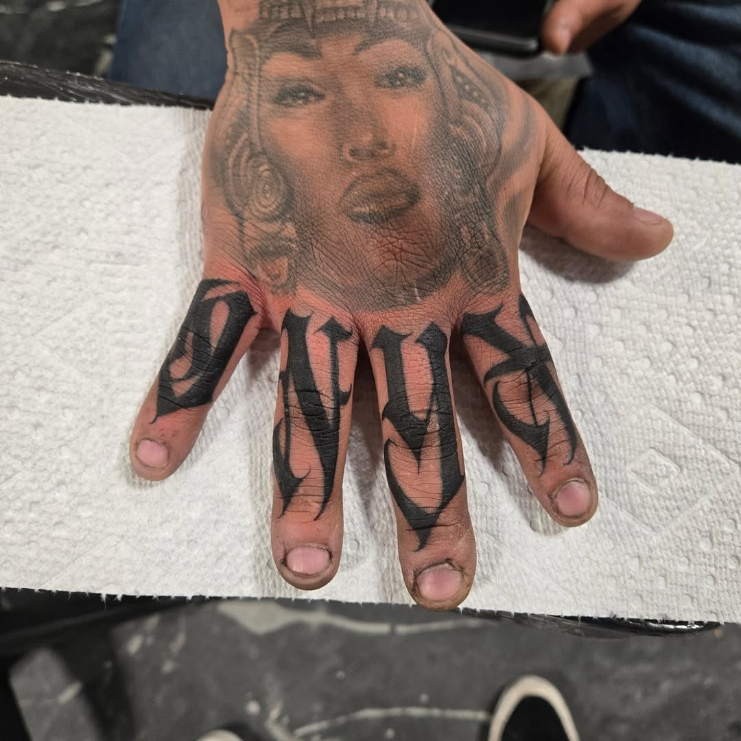 Bold blackletter finger lettering spelling ONYX across four digits