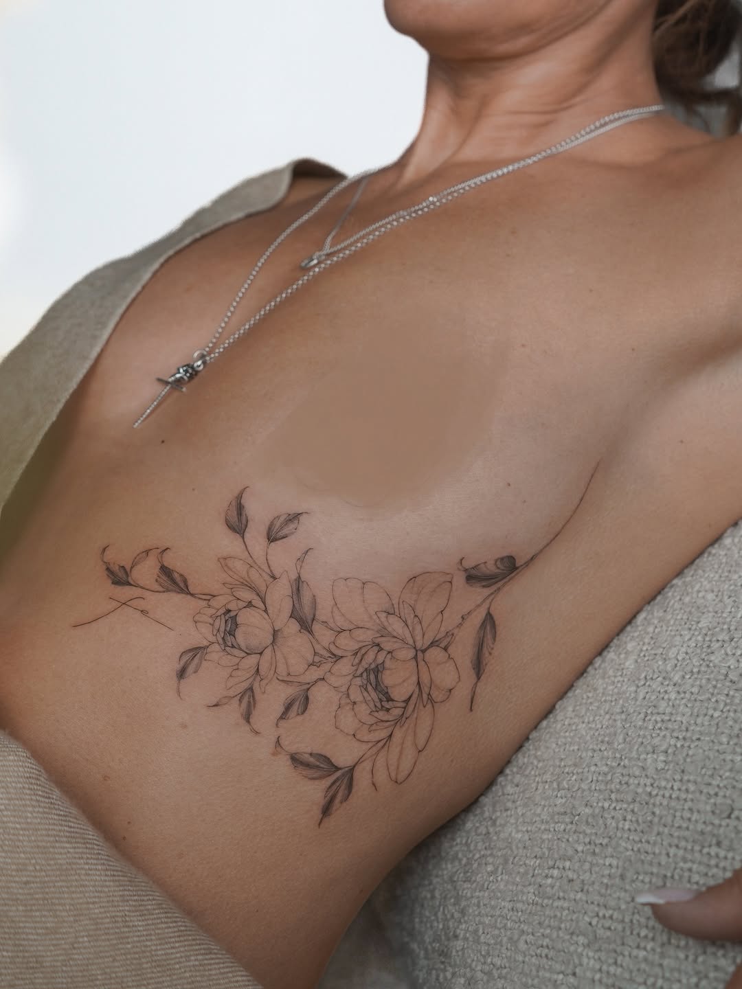 Elegant floral peonies etched in fine-line across chest.