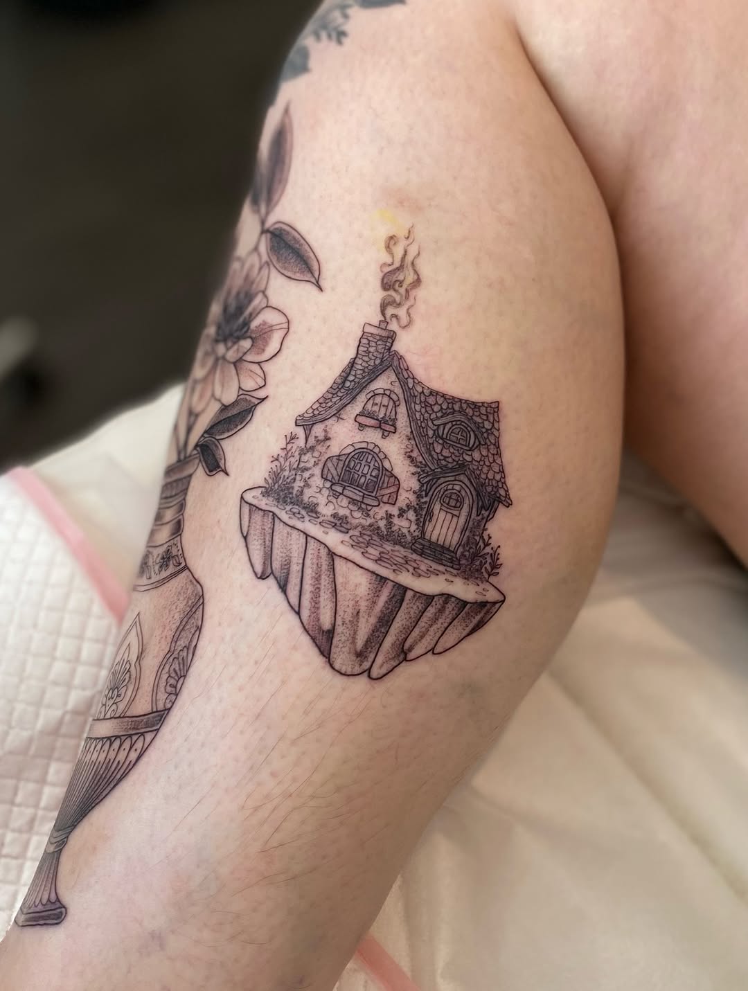 Whimsical floating island cottage with curling chimney.