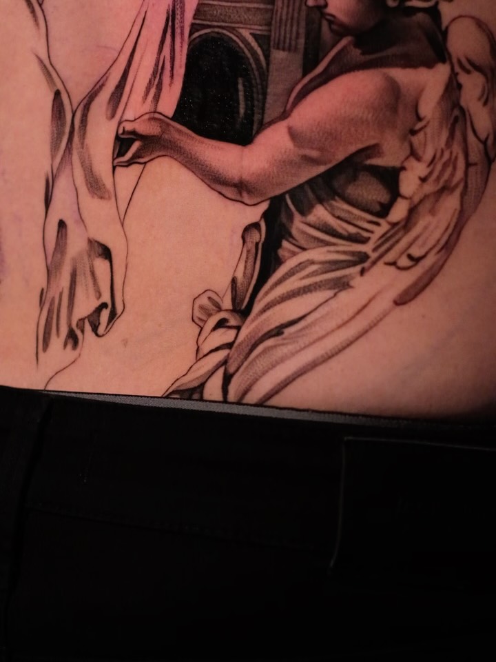 Intricate black-and-gray linework on torso, dramatic drapery.