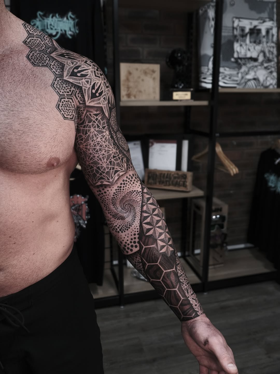 Dramatic geometric forearm sleeve with hex tessellations and dotwork shading