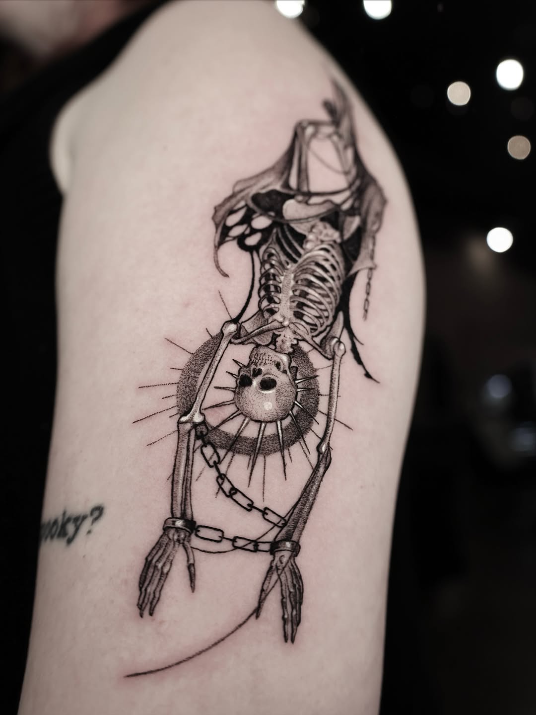 Intricate skeletal humanoid figure with sunburst halo