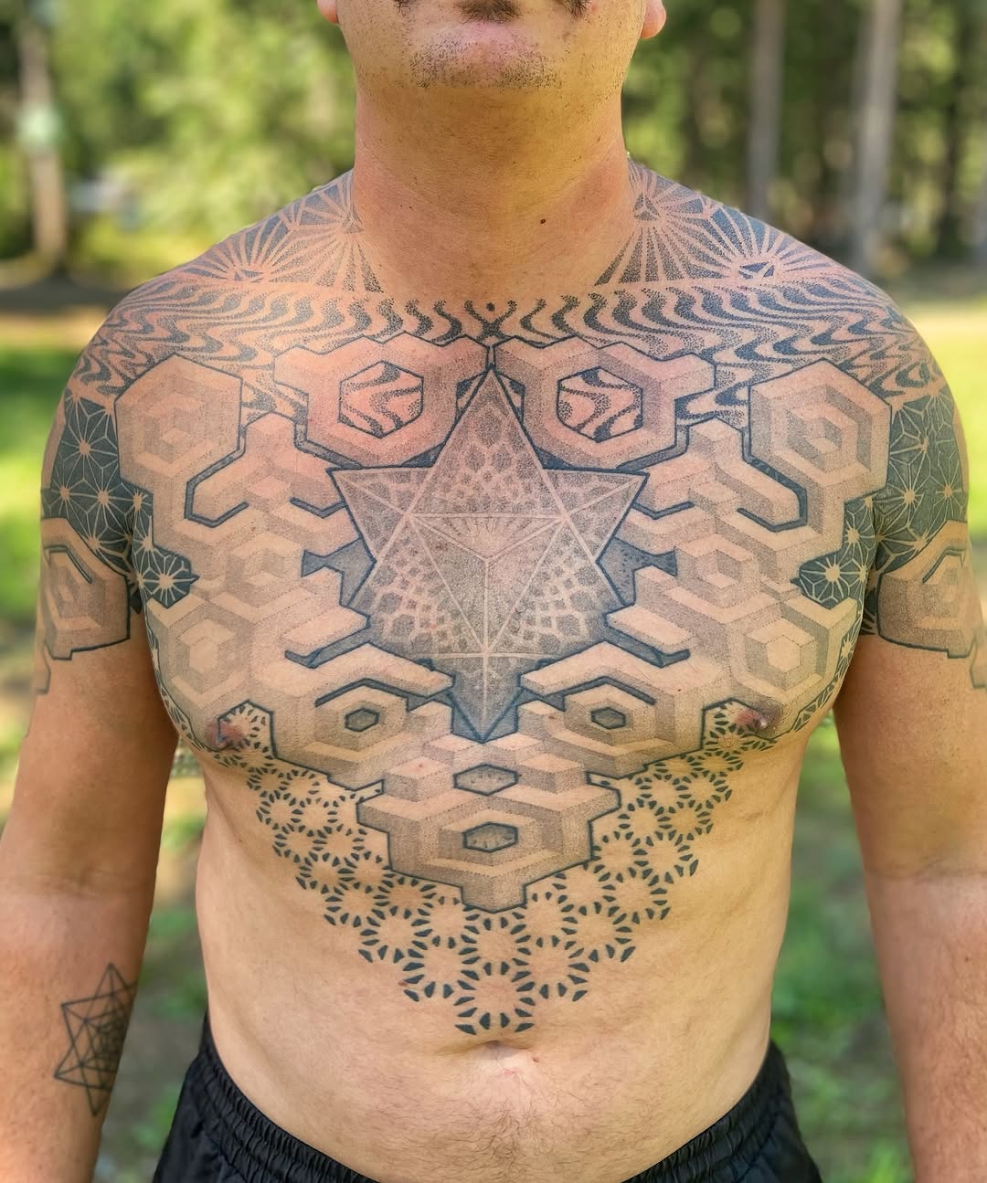 Central geometric polyhedron with hexagonal tessellations across chest