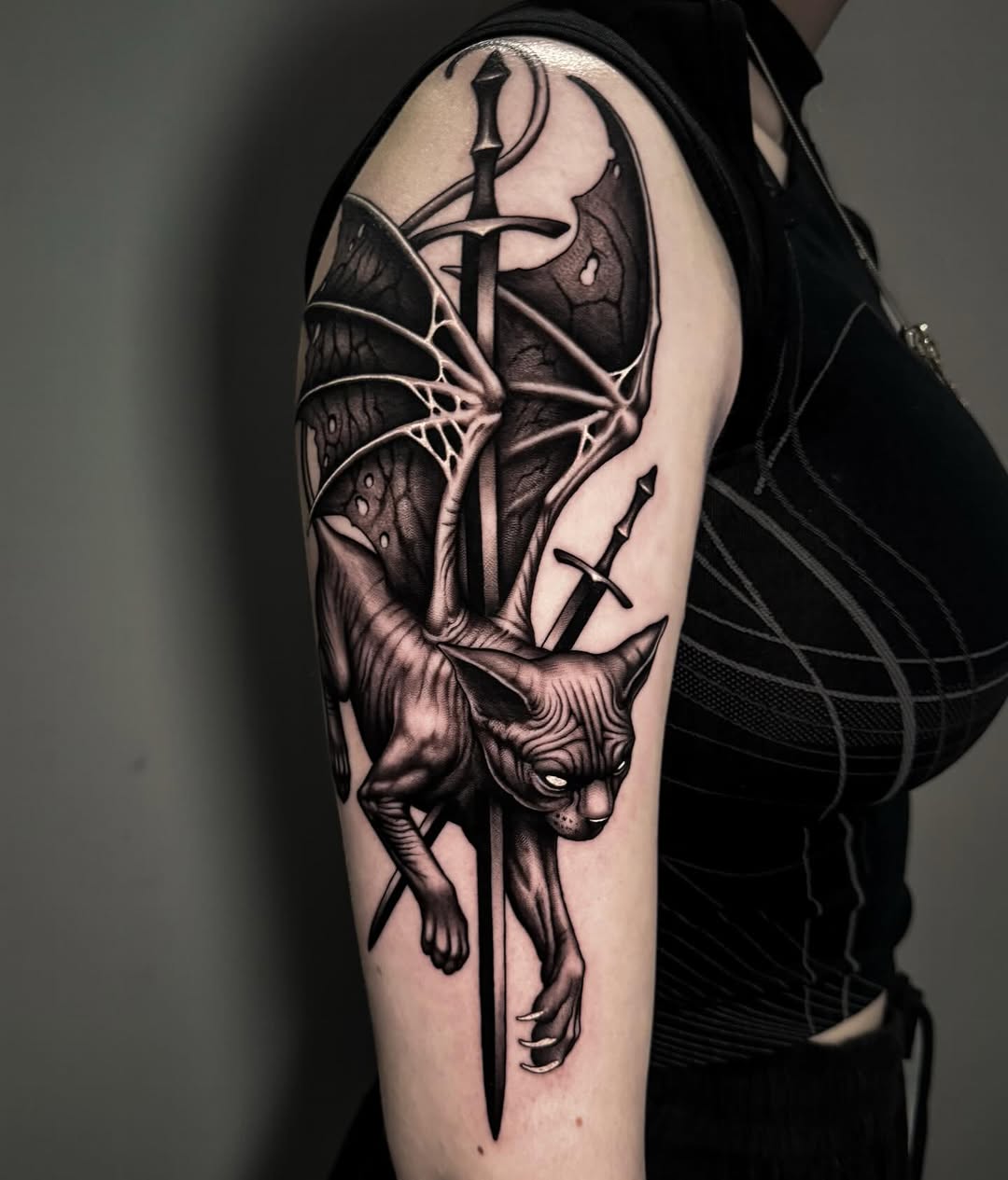 Gothic blackwork cat with dagger and winged backdrop