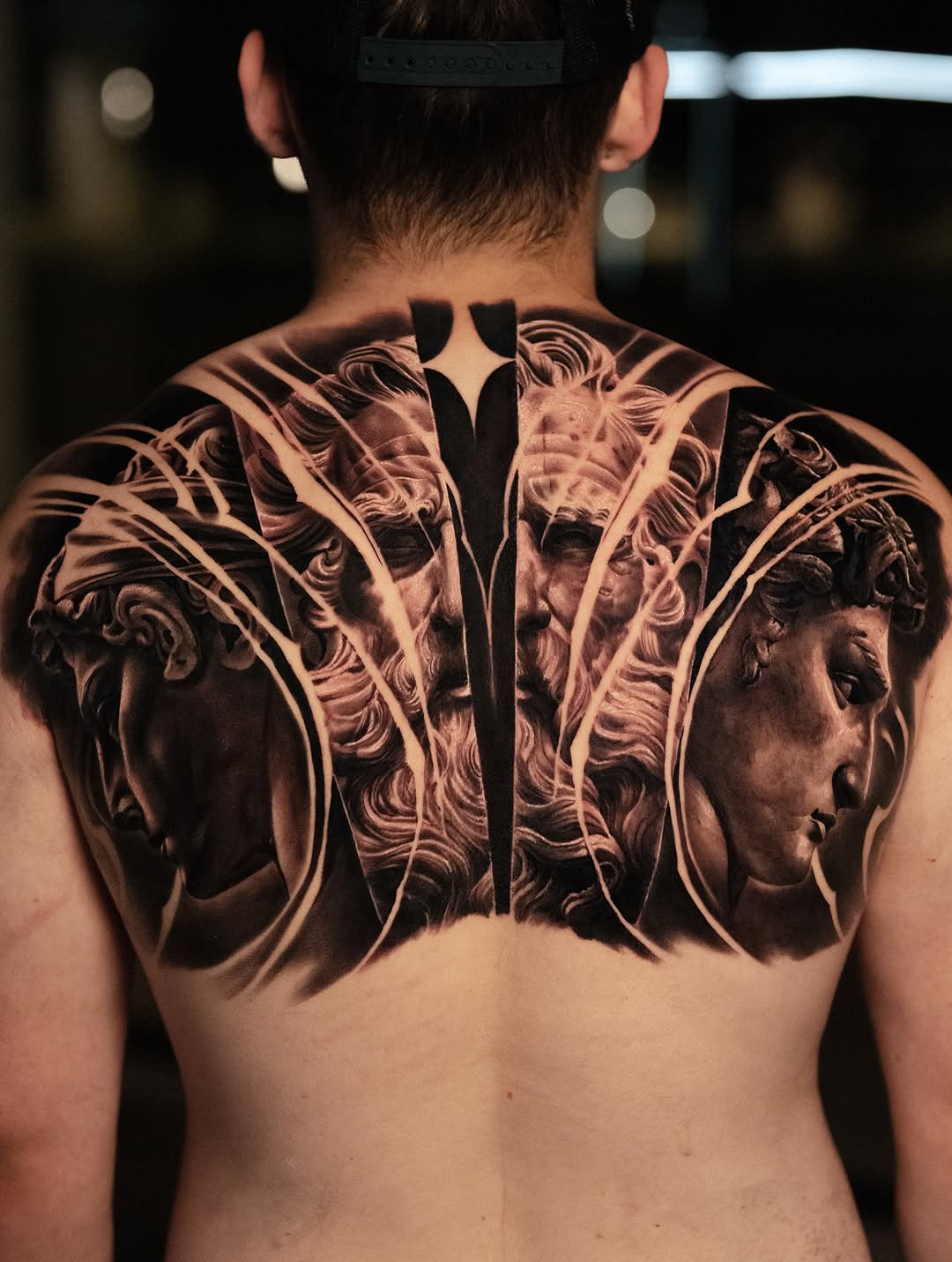 Striking black-and-gray back piece featuring two classical busts