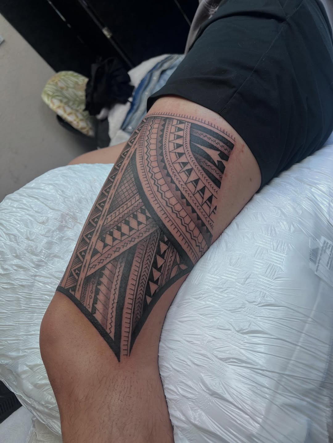 Bold black Polynesian tribal thigh piece with geometric bands