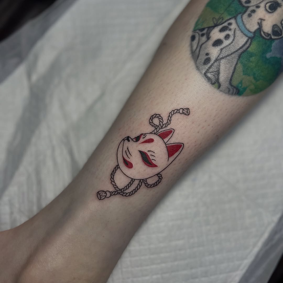 Kitsune mask tattoo with red accents and rope
