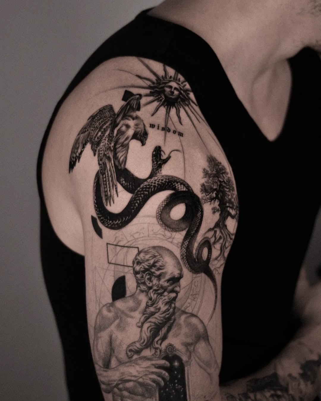 Intricate black-and-gray sleeve with sun, serpent, and bust.