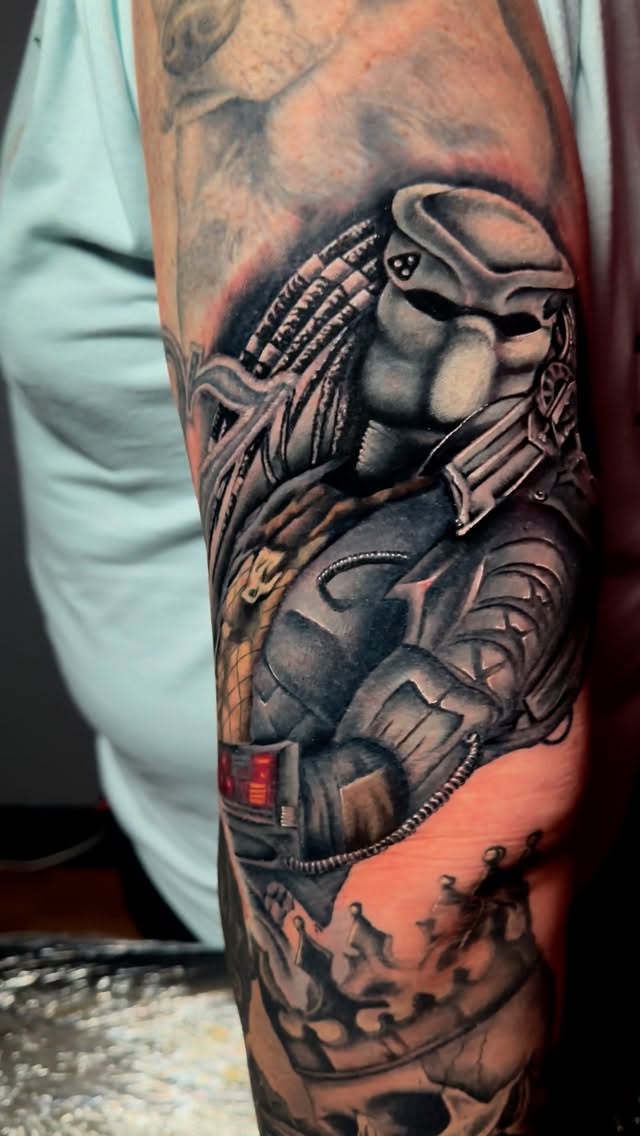 Hyper-detailed Predator helmet and armor on forearm