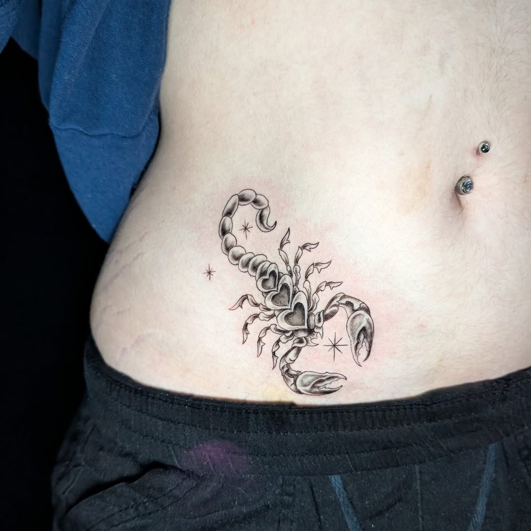 Blackwork scorpion with heart-shaped tail segments and stars