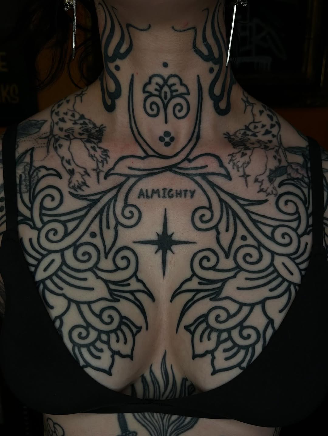 Intricate blackwork back-piece with flowing scrolls and 'ALMIGHTY' script