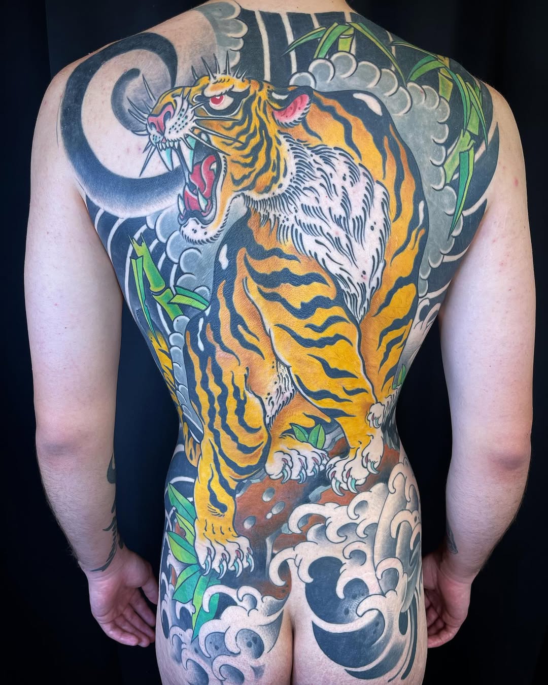 Vivid Japanese tiger with crashing waves and bamboo