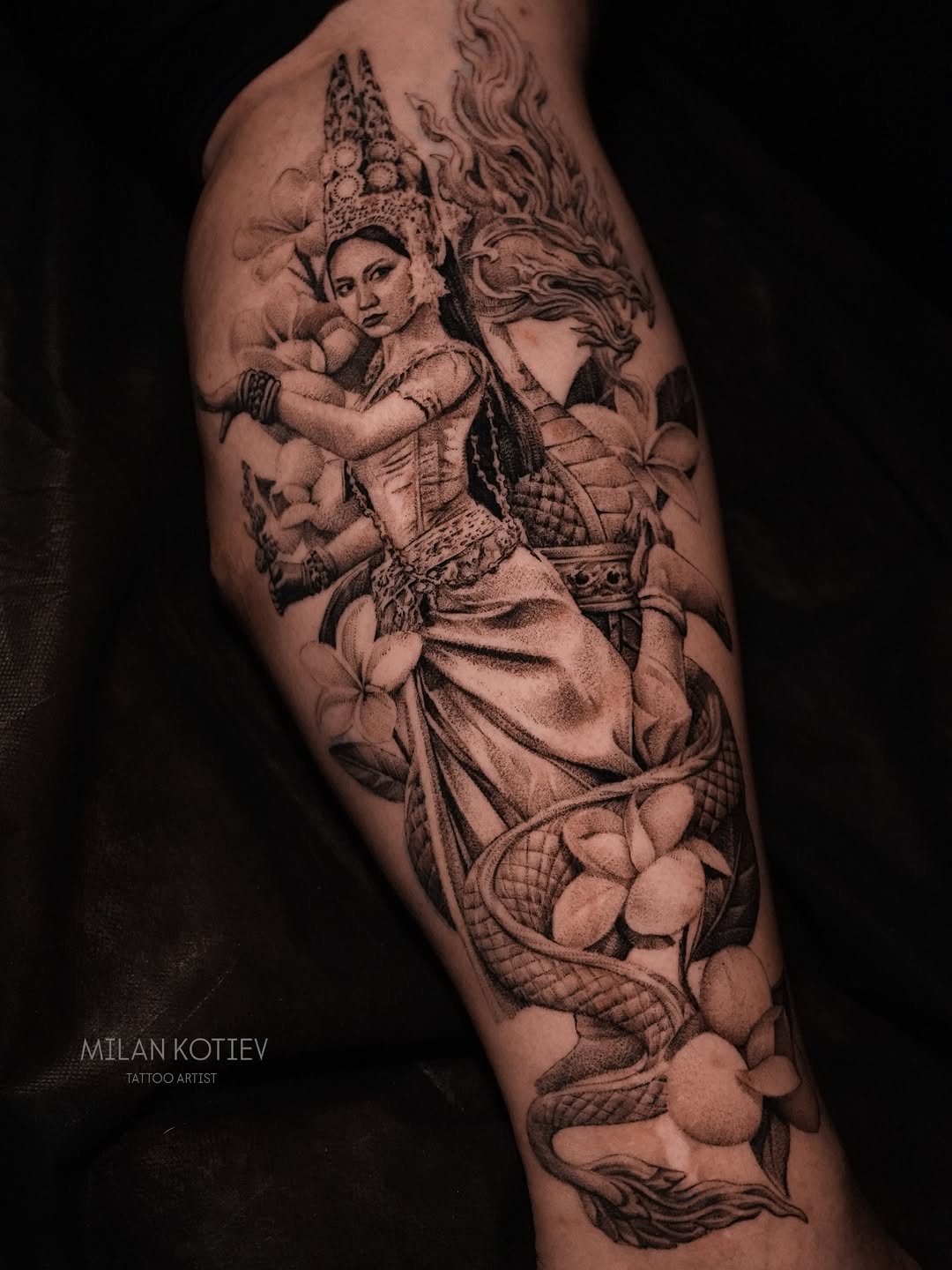 Elegant black-gray Apsara dancer entwined with a Naga.