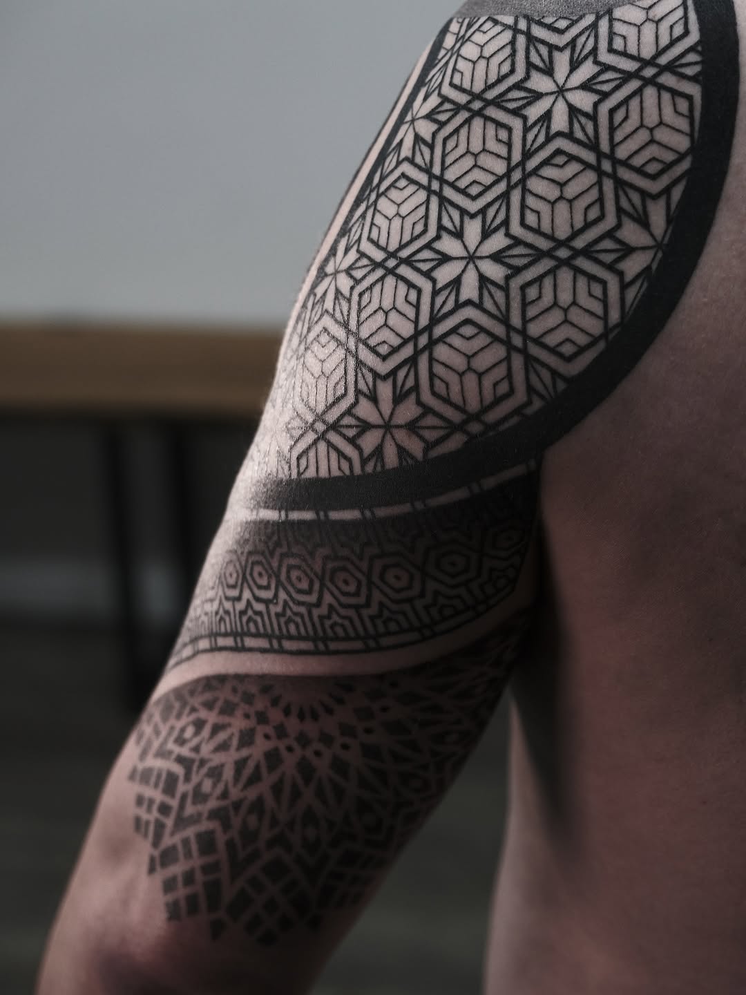 Intricate geometric hexagonal tessellation sleeve with bold black lines