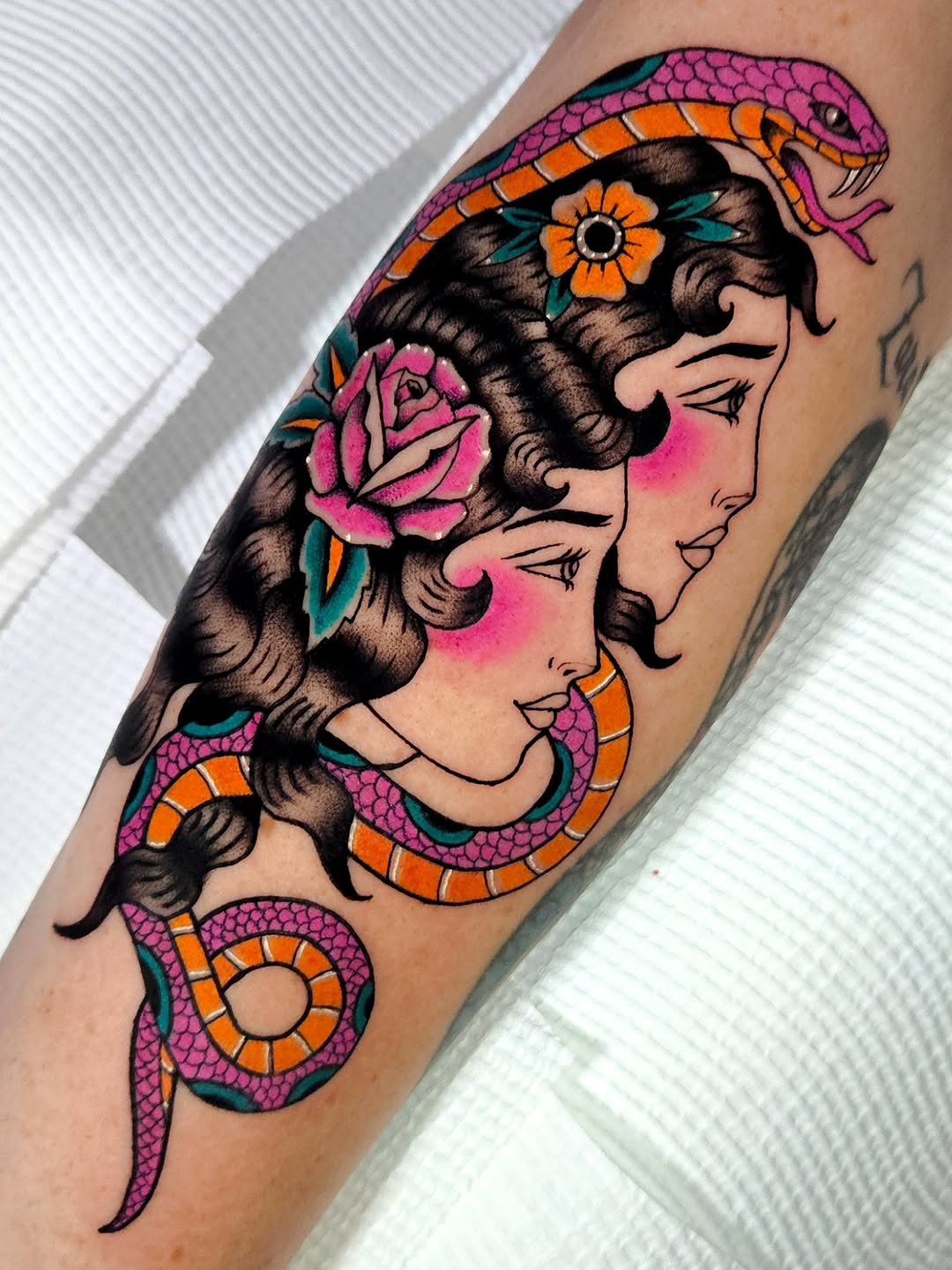Vibrant neo-traditional dual-face portrait with pink snake.