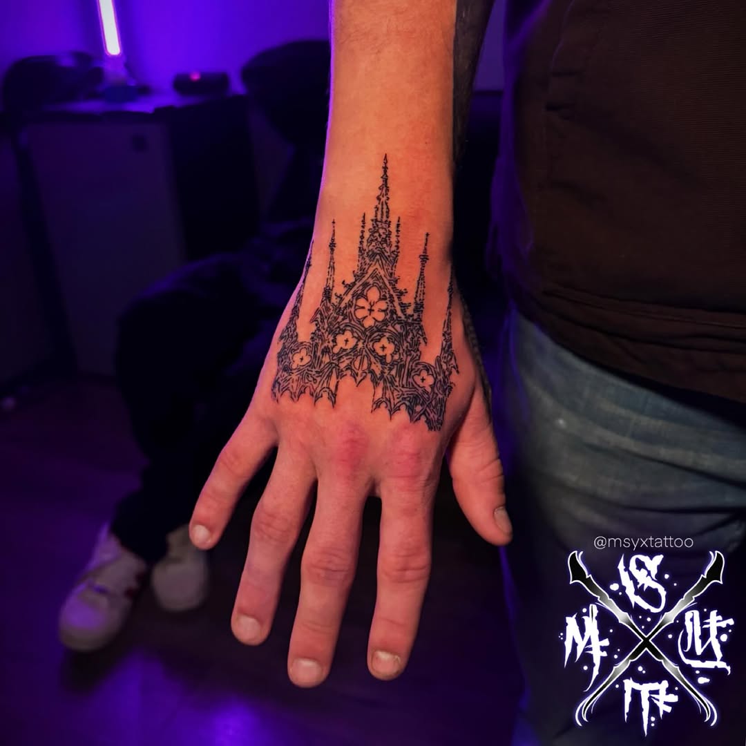 Intricate blackwork cathedral silhouette with lace-like floral details