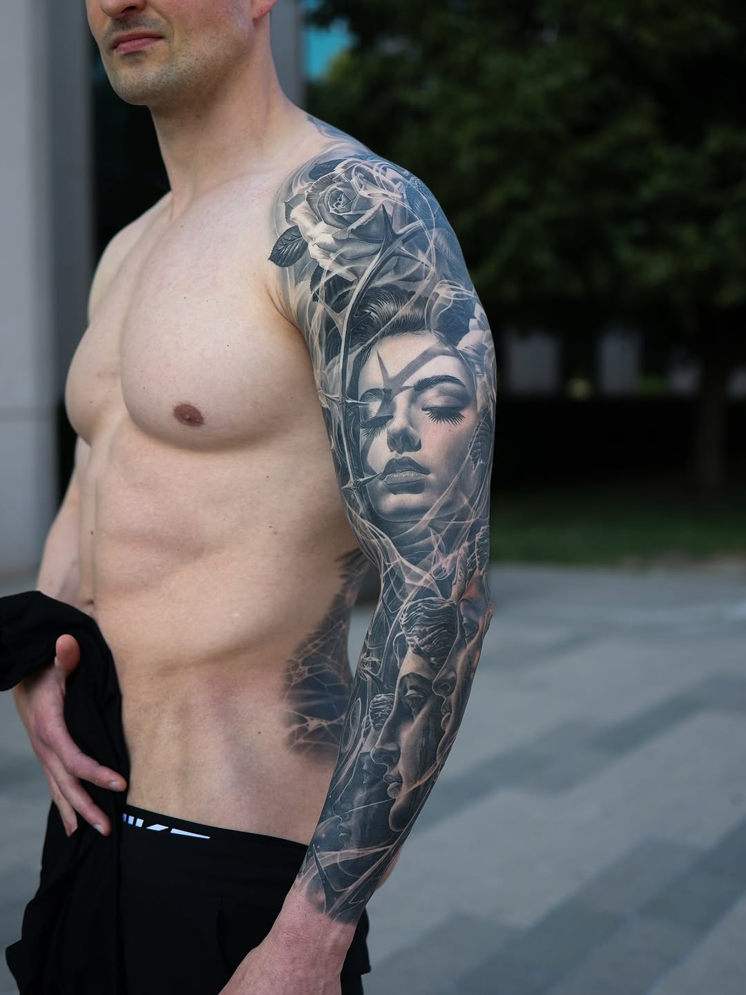 Hyper-detailed grayscale portrait sleeve with blooming roses.