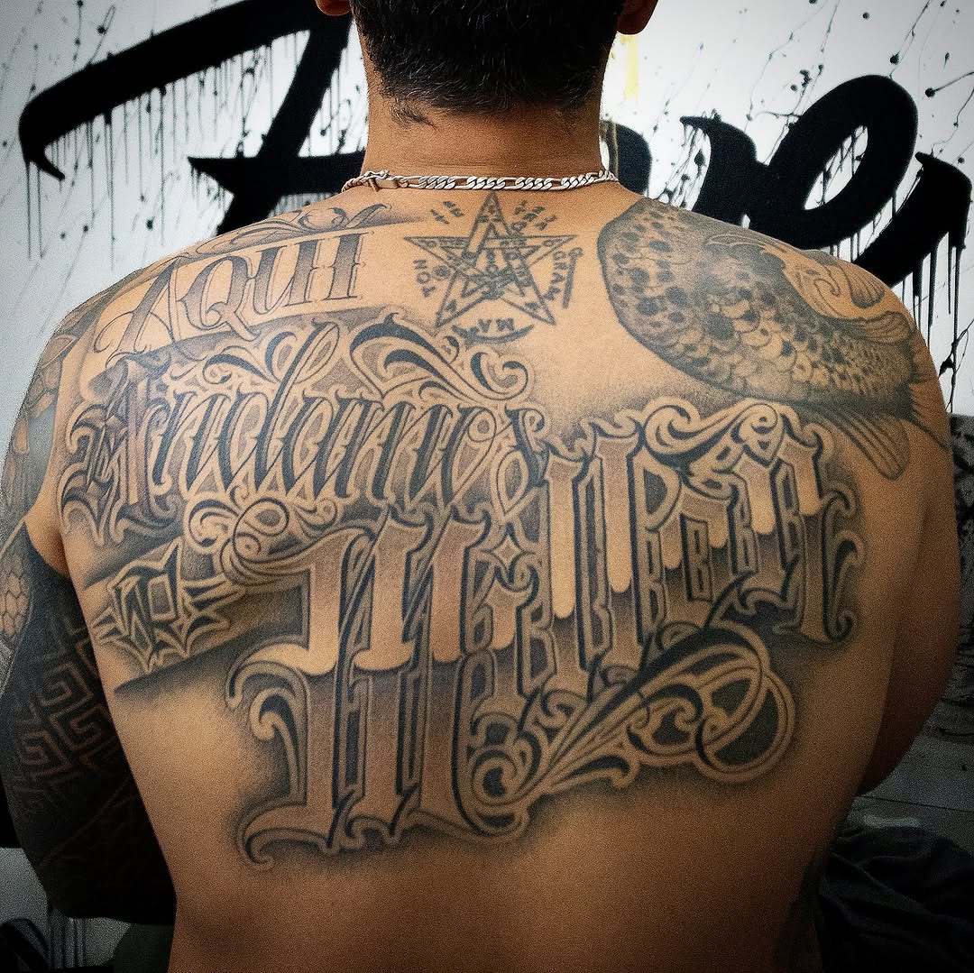 Intricate blackletter back piece with ornate flourishes